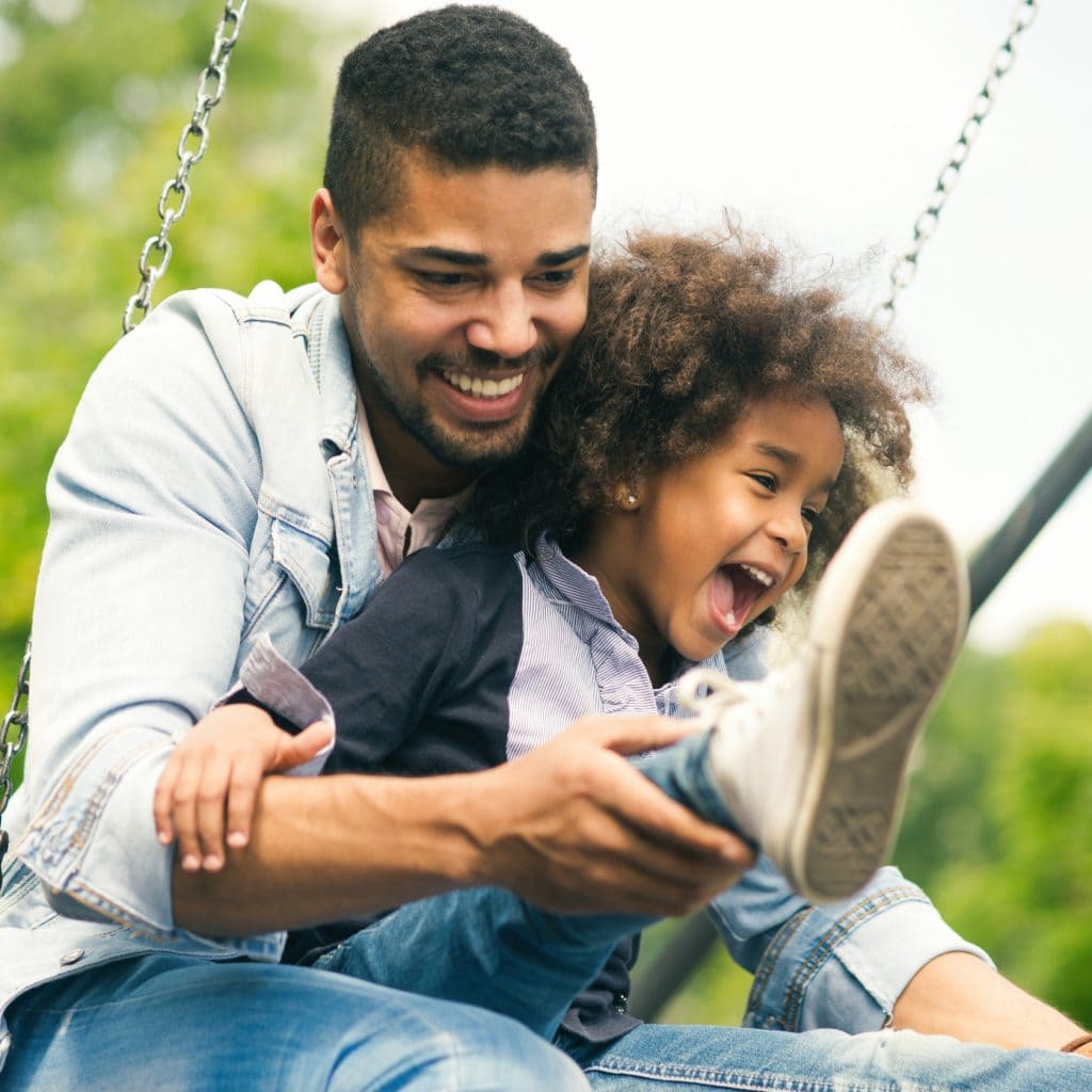 Father and child on a swing